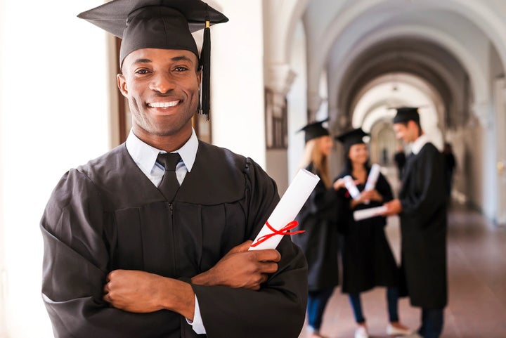 college graduate holding his diploma | Romano Subaru in Syracuse NY