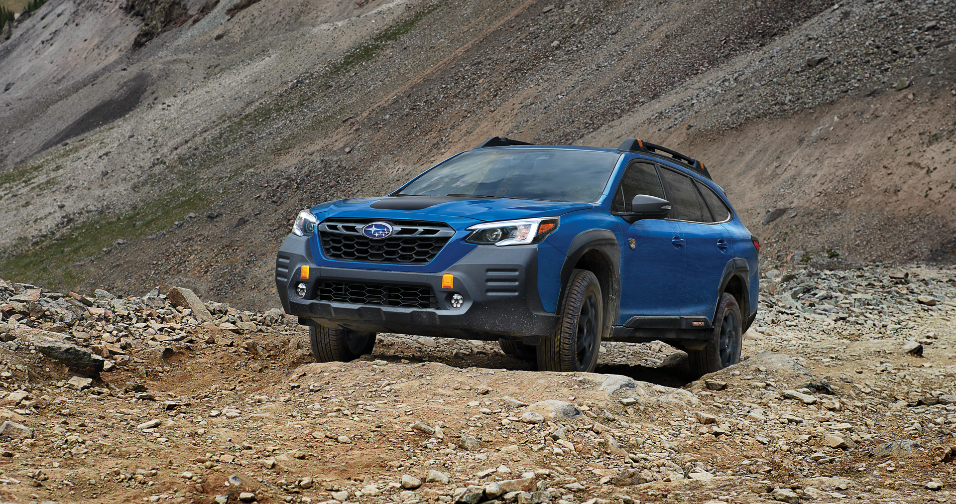 A 2023 Outback Wilderness driving on a trail in the mountains. | Romano Subaru in Syracuse NY